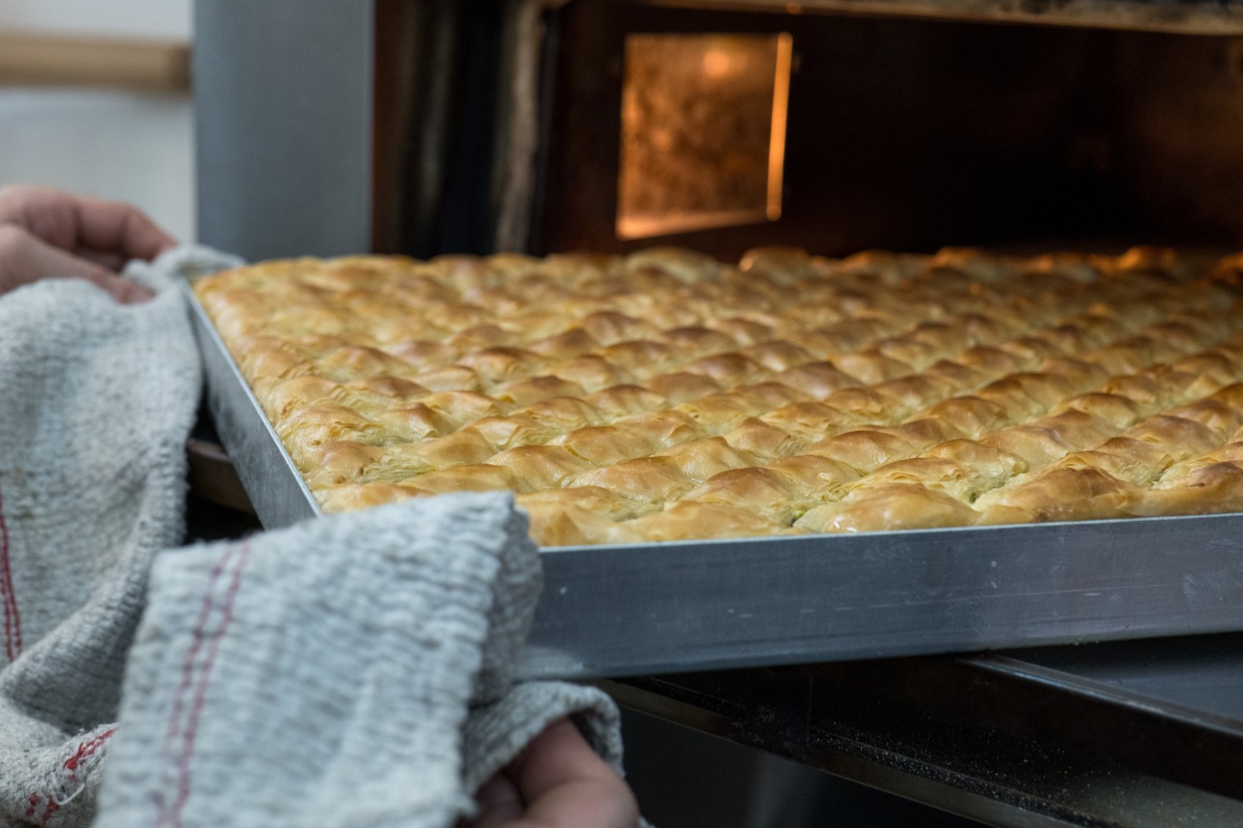 A tray of baklava coming out of the oven